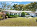 Inviting single-Gathering home with lush landscaping, arched entry, and a well-manicured front lawn at 115 Shepherd Trl, Longwood, FL 32750