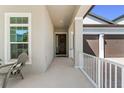 Covered front porch with seating and a view of the home's exterior at 14661 Glade Hill Park Way, Winter Garden, FL 34787