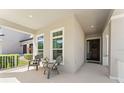 Inviting covered front porch with seating area and view of the neighborhood at 14661 Glade Hill Park Way, Winter Garden, FL 34787