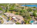 Aerial view showcasing the community, mature trees, nearby lake and pool at 1912 Abbington St # Ge, Apopka, FL 32712