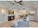 Spacious living room boasts a vaulted ceiling, fireplace, and open dining area at 1912 Abbington St # Ge, Apopka, FL 32712