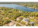 Aerial view showcasing the property's expansive lot and proximity to a large lake at 1984 Windermere Rd, Windermere, FL 34786