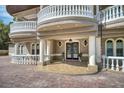 Detailed view of front entrance with stately columns and wrought iron detailing on balconies at 1984 Windermere Rd, Windermere, FL 34786