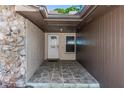 Welcoming covered front entrance featuring tile flooring, a white door, and stone wall accents at 320 Dublin Dr, Lake Mary, FL 32746