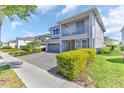 Contemporary home with a balcony, manicured landscaping, and a brick driveway at 501 Burma St, Kissimmee, FL 34747