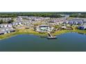 Scenic aerial shot showcasing a community pool, playground, and a pier on the lake at 5074 Sparkling Water Way, Kissimmee, FL 34746