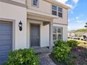 Close-up of front porch with manicured landscape and brick walkway leading to a gray front door at 5074 Sparkling Water Way, Kissimmee, FL 34746