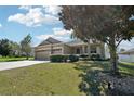 Well-maintained home featuring lush landscaping and a spacious driveway with ample parking at 5832 Tarleton Way, Mount Dora, FL 32757