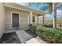 Inviting front entrance with covered porch, well-maintained landscaping, and charming details at 5832 Tarleton Way, Mount Dora, FL 32757