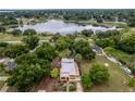 Aerial view of home showcasing lush backyard, and neighborhood pond at 809 Poinsettia Dr, Eustis, FL 32726