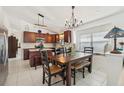 Eat-in kitchen featuring wood cabinets, tile backsplash, and a dining area at 1120 Parker Canal Ct, Oviedo, FL 32765