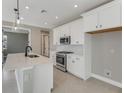 Bright kitchen with white cabinets, stainless steel appliances, and an island sink at 1276 Jackson Hole Ct, Deland, FL 32724