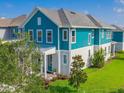 Beautiful home featuring blue siding, white trim, well-manicured lawn, and inviting front porch at 13087 Salk Way, Orlando, FL 32827