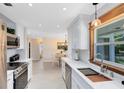 Bright kitchen features white cabinets, quartz countertops, and stainless steel appliances at 1338 Franklin St, Altamonte Springs, FL 32701