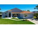 Well-maintained single-story home featuring a manicured lawn and bright, inviting entrance at 14901 Wild Wood Lily Ct, Orlando, FL 32824