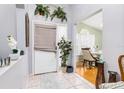 Inviting foyer featuring tiled floors, neutral paint, and a view into the adjacent dining area at 1562 Woodwind Dr, Apopka, FL 32703