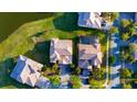Stunning aerial view of properties surrounded by manicured lawns and a serene lake, showcasing community layout at 2110 Majestic Eagle Pl, Kissimmee, FL 34746