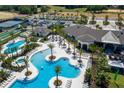 Stunning aerial view of a resort-style pool area with palm trees, sun loungers, and various amenities at 2168 Seagrass Pt # 424, Kissimmee, FL 34747