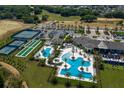 Overhead view of a community pool with palm trees, a clubhouse, and recreational facilities at 2168 Seagrass Pt # 424, Kissimmee, FL 34747