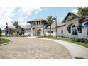 Elegant clubhouse with a porte-cochere entrance, well-maintained landscaping, and ample parking at 2168 Seagrass Pt # 424, Kissimmee, FL 34747
