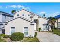 Inviting two-story home with a well-kept lawn, complemented by a palm tree in the front yard at 218 Castlemain Cir, Davenport, FL 33897