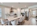 Modern kitchen boasts a large island, stainless steel appliances, and sleek white cabinets at 2277 Crossbow St, Clermont, FL 34715
