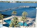 A stunning aerial view shows the waterfront pool and pier, framed by lush palm trees at 231 Riverside Dr # 708, Daytona Beach, FL 32117