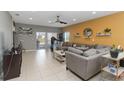 Bright living room features tile flooring, ceiling fan and sliding glass doors for seamless indoor-outdoor living at 233 Primrose Dr, Davenport, FL 33837