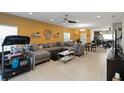 Open-concept living area with tile floors, ceiling fan, and direct access to the dining and kitchen areas at 233 Primrose Dr, Davenport, FL 33837