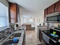 Modern kitchen showcases granite countertops, stainless appliances, and open layout to the living area at 2480 Alamanda Ave, Deltona, FL 32738
