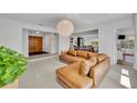 Spacious open-concept living area with a brown sectional couch, wooden accents, and views into other rooms at 2732 Lion Heart Rd, Winter Park, FL 32792