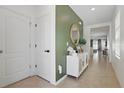 Inviting entryway features tile flooring, an accent wall, and stylish decor that leads into the home at 2839 Common Crane Ct, Harmony, FL 34773