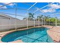 Sparkling pool with clear blue water and brick surround in a screened enclosure at 2839 Drifting Lilly Loop, Kissimmee, FL 34747