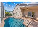 Inviting screened-in pool area with comfortable seating, perfect for relaxing or entertaining at 2839 Drifting Lilly Loop, Kissimmee, FL 34747
