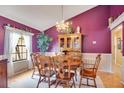 Cozy dining room with wood furniture, light hardwood floors, and a decorative chandelier at 2910 S Whisperbay Ct, Oviedo, FL 32765