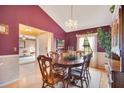 Elegant dining room with wood table, chandelier, and views into the adjacent living area at 2910 S Whisperbay Ct, Oviedo, FL 32765