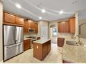 Modern kitchen with stainless steel appliances, granite countertops, and ample cabinet space at 30411 Gidran Ter, Mount Dora, FL 32757