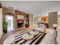 Inviting living room with fireplace, stylish furniture, and an open floor plan at 30411 Gidran Ter, Mount Dora, FL 32757