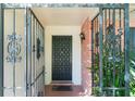 Close-up of the home's front door, surrounded by decorative ironwork and brick accents at 4366 Roanne Dr, Orlando, FL 32817