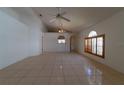 Bright living room with tile floors, arched window, and vaulted ceilings at 458 Cadenza Dr, Orlando, FL 32807