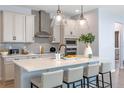 Modern kitchen with quartz countertops, stainless steel appliances, and pendant lighting at 4630 Cragmere Loop, Clermont, FL 34711