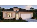 Charming single-story home featuring a two-car garage, neutral color palette, and well-maintained landscaping at 4895 Lyric Dr, Mascotte, FL 34753
