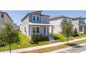 Charming home with a covered front porch, neat landscaping, and inviting curb appeal at 4994 Citrus Leaf Blvd, Winter Garden, FL 34787