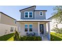 Charming two-story home featuring a covered porch and well-maintained landscaping at 4994 Citrus Leaf Blvd, Winter Garden, FL 34787
