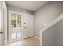 Bright foyer with neutral tones, tile flooring, and natural light streaming through the window at 6114 Peregrine Ave # D03, Orlando, FL 32819
