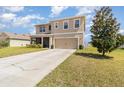 Charming home features a two-car garage, manicured lawn, and mature landscaping adding to its curb appeal at 9731 Pepper Tree Trl, Wildwood, FL 34785