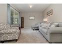 Inviting living room with neutral walls, plush carpeting, and comfortable seating, creating a cozy atmosphere at 9731 Pepper Tree Trl, Wildwood, FL 34785