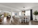 Open-concept dining area featuring a modern light fixture, stylish furnishings, and seamless flow to other living spaces at 1025 Augustus Dr, Davenport, FL 33896