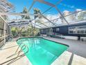 Enclosed, private pool with an aluminum frame and screen; clear blue water with ladder for relaxing swims at 1041 Osceola Trl, Casselberry, FL 32707