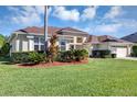 Charming one-story home with lush front lawn, manicured landscaping, and a two-car garage at 14149 Islamorada Dr, Orlando, FL 32837